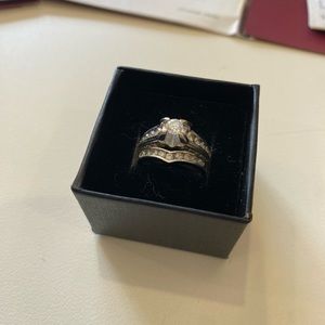 Helzberg “Vivian” white gold engagement ring and matching wedding band.